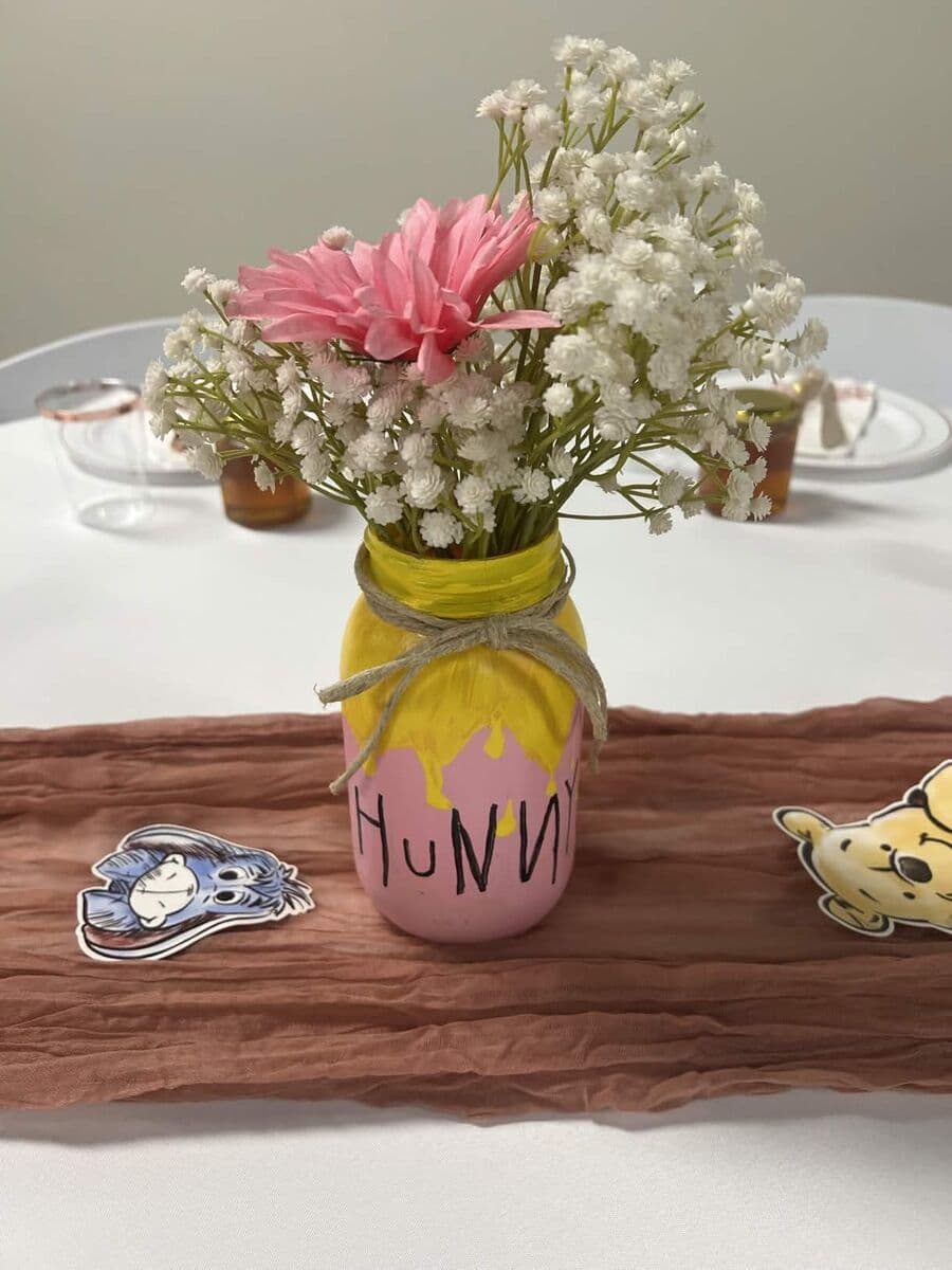 Classic Winnie the Pooh theme with Hunny jar centerpiece and character cutouts